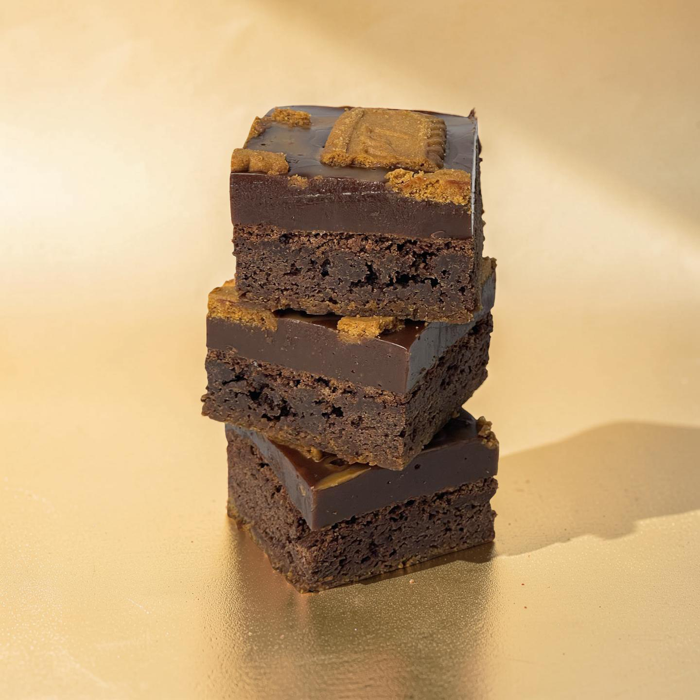 Chocolate-covered cookies with visible brand logo on a grid background