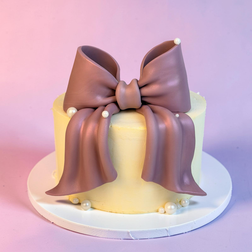 Cake with a large brown bow on a gradient pink and purple background