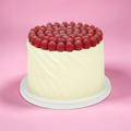 Cake with raspberry topping on a pink background