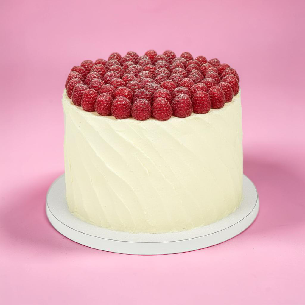 Cake with raspberry topping on a pink background
