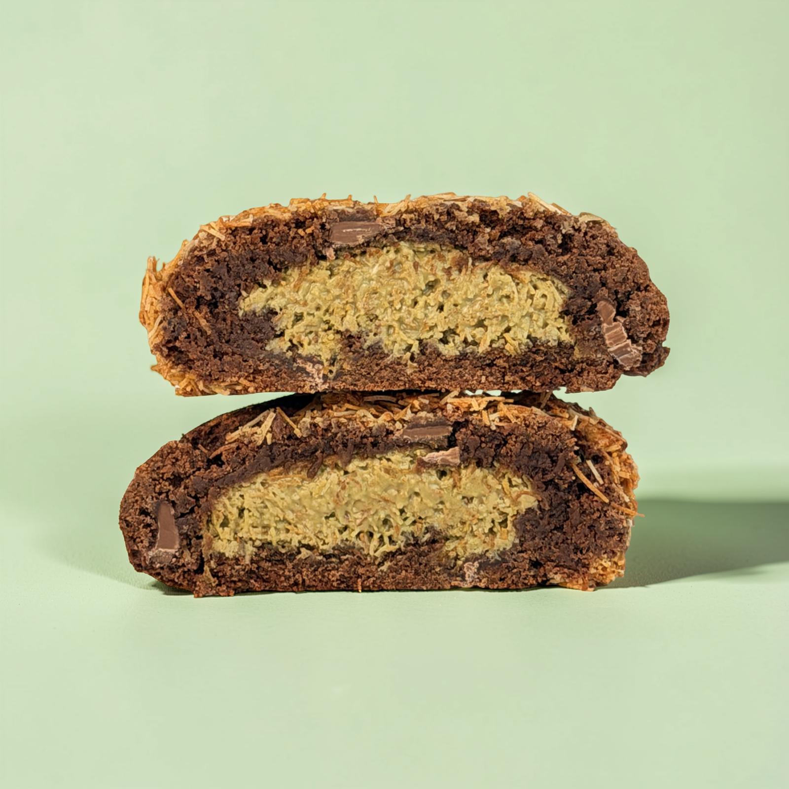 Chocolate cookie with a peanut butter filling on a light green background