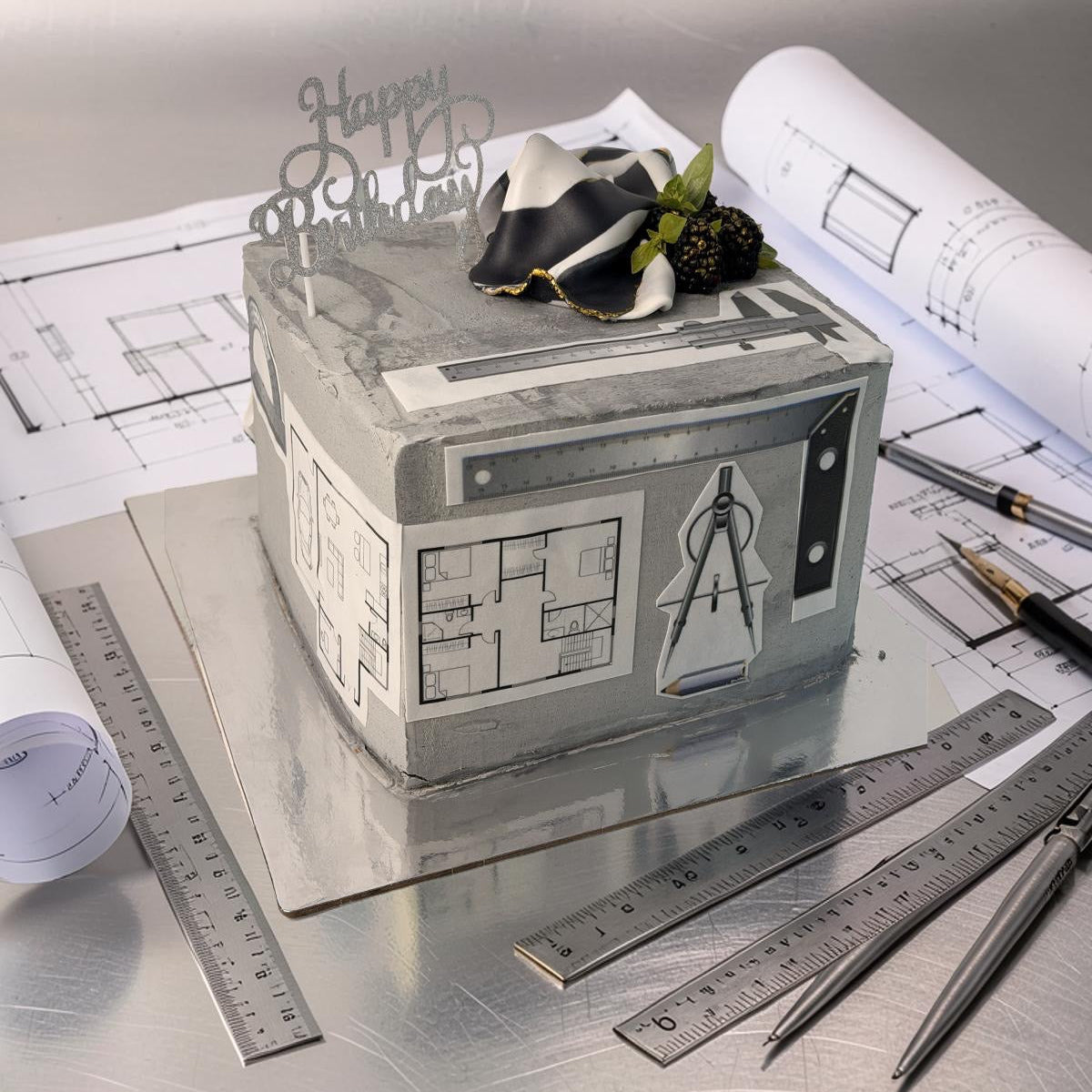 Decorative box with architectural design on a table with blueprints and tools